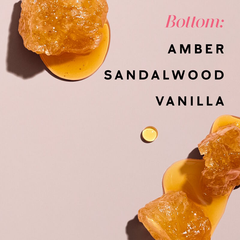 Drops of amber appear on a light pink background