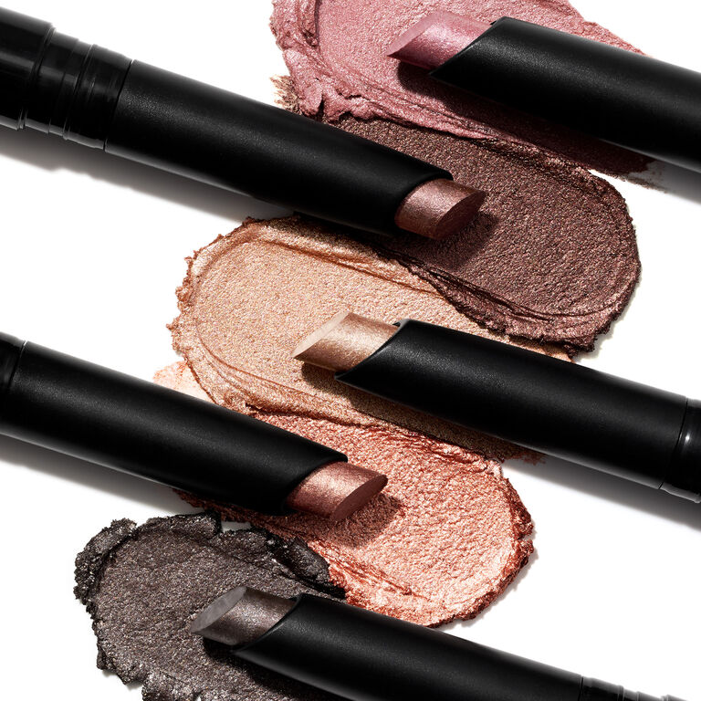 Mary Kay eye shadow sticks in multiple shades with textured swatches on a white background.