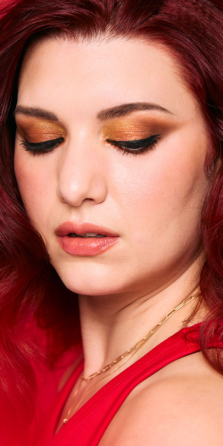Woman with fair skin showcasing a gold shimmer eyeshadow look
